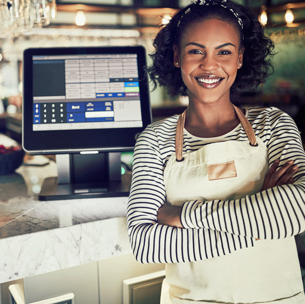 store owner standing by cash register